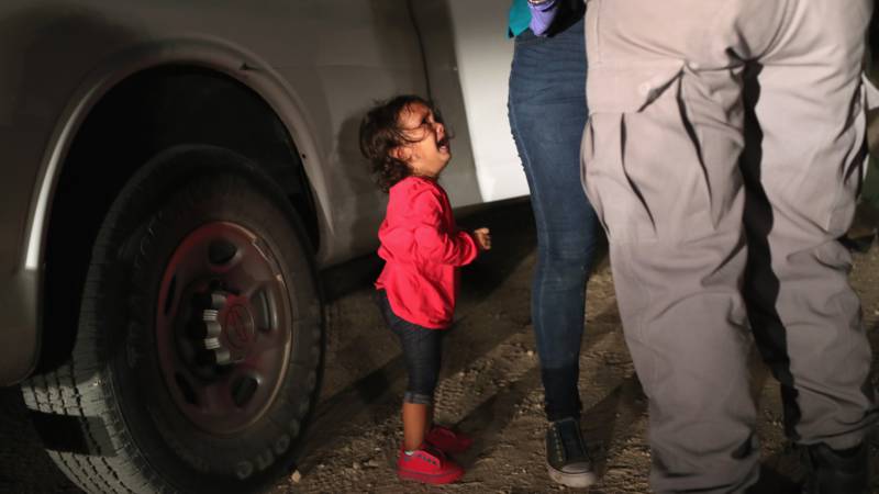 A two-year-old girl from Honduras cries as her mother gets strip searched and arrested at the USA-Mexican border. Photo by John Moore/Getty Images