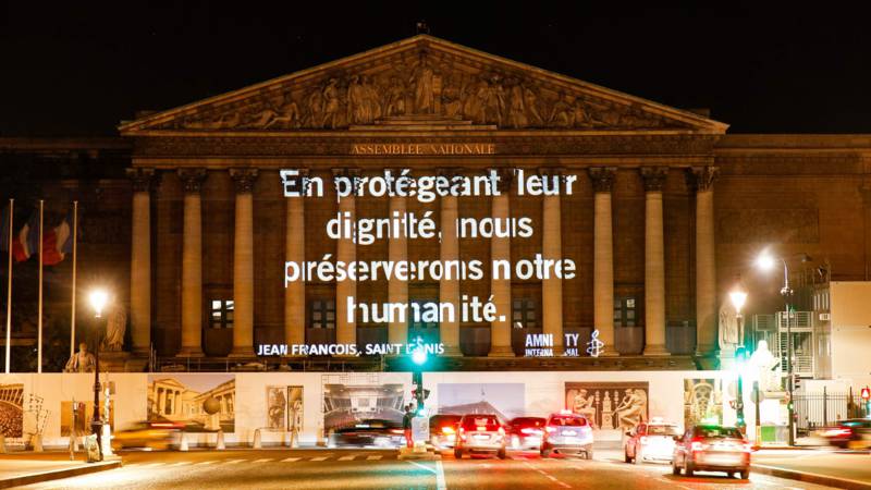 Amnesty protest slogan in Paris: By protecting their [the refugees'] dignity, we preserve our humanity. AFP photo