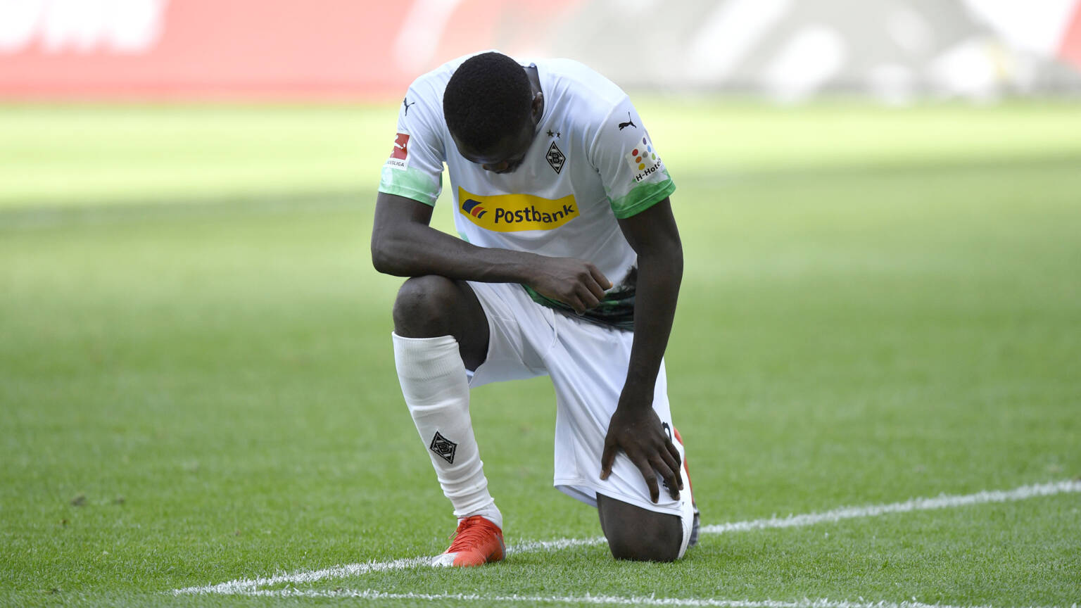 Footballer Marcus Thuram kneels in protest against police brutality in the USA